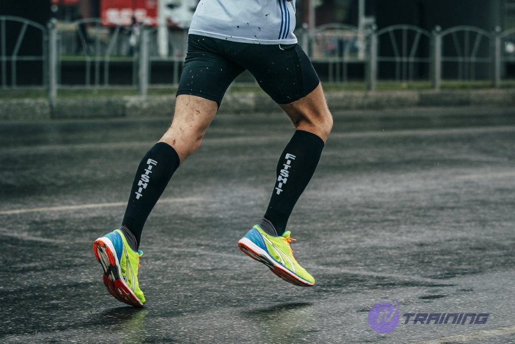 a man is running with compression running socks