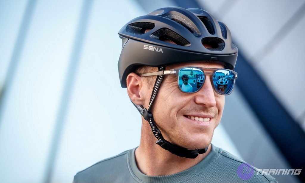 a man smiling wearing cycling helmets