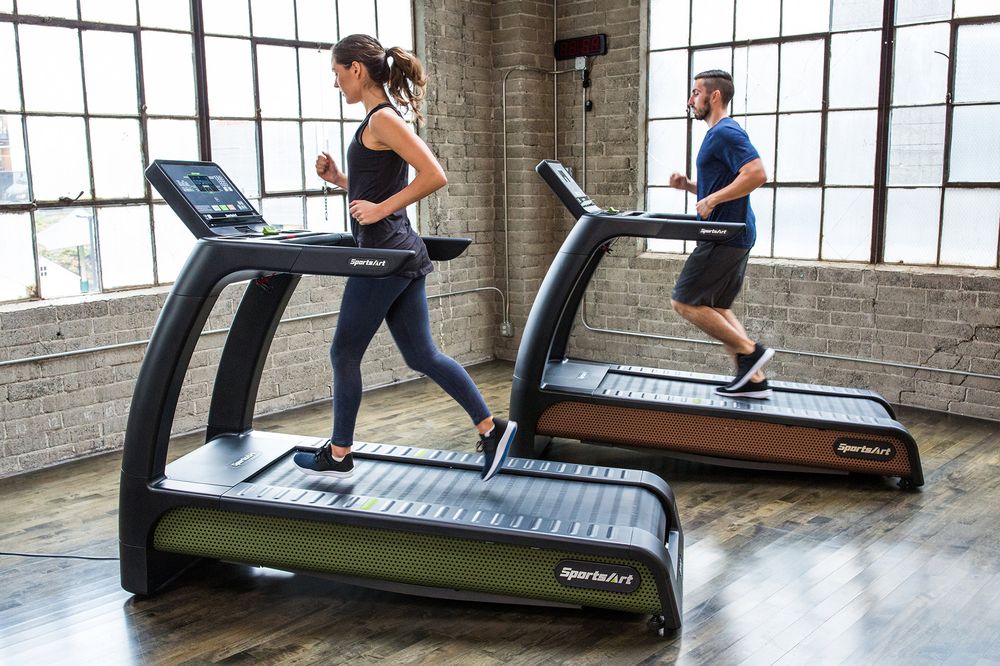 a couple is running on treadmill